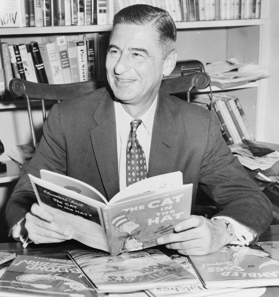 Dr. Seuss (American writer and cartoonist, Ted Geisel) holding "The Cat in The Hat" (1957)